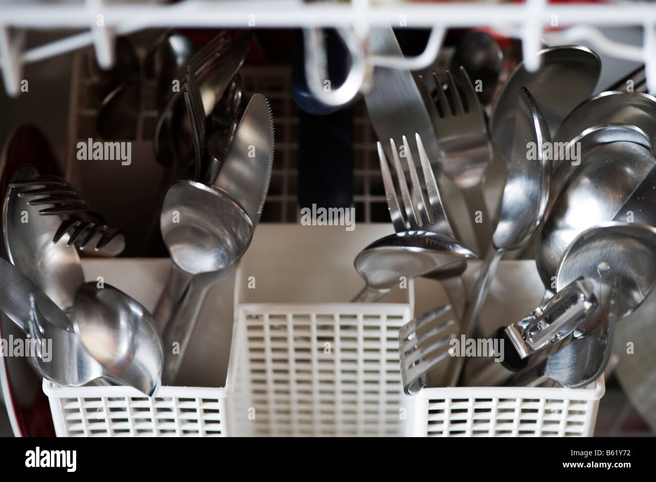 Cutlery in the cutlery basket of a dishwasher, detail Stock Photo Alamy