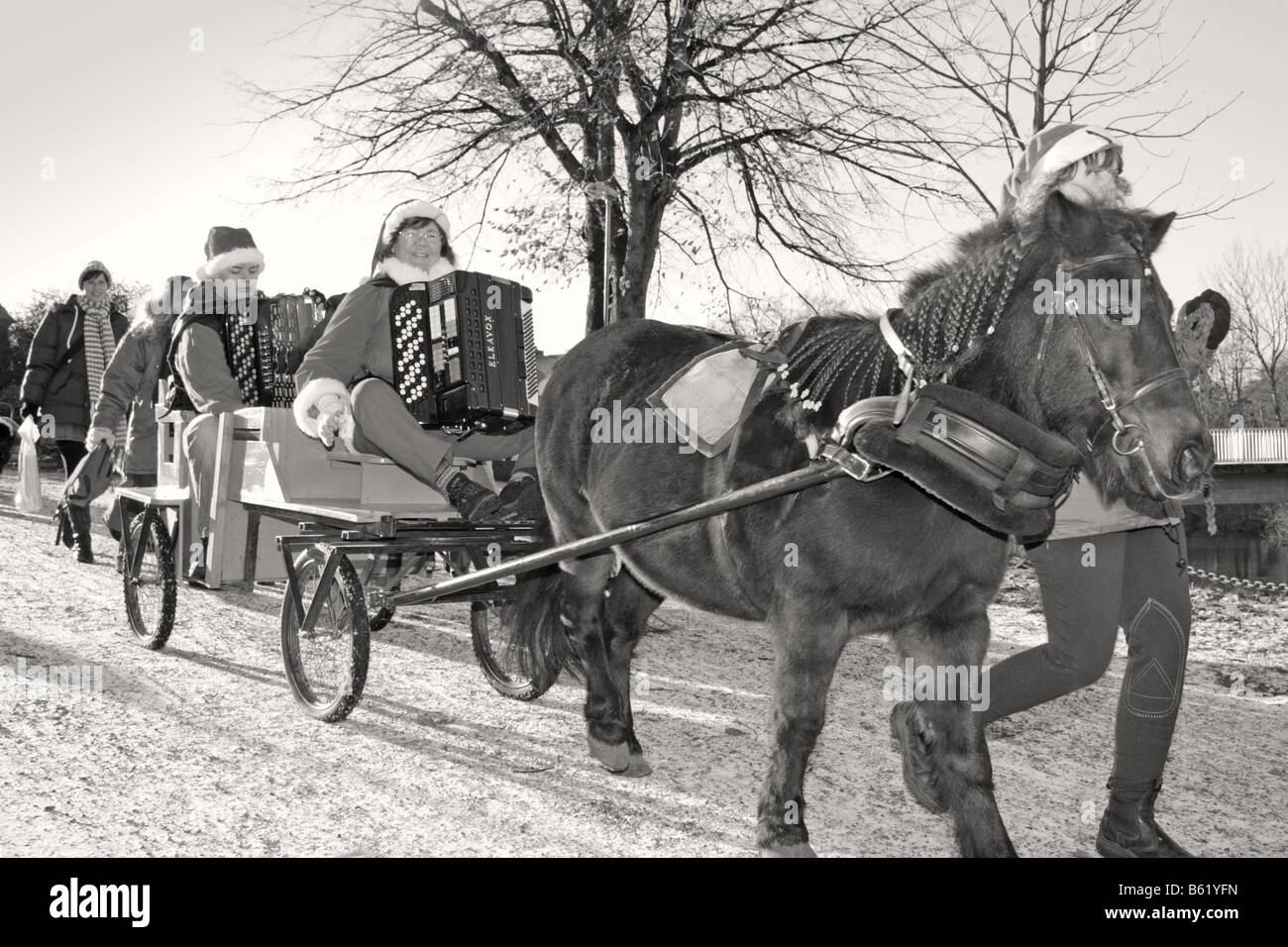 Santa claus parade with horse wagon at swedish traditional Christmas celebration svensk tomteparad med häst och vagn s/v b/w Stock Photo
