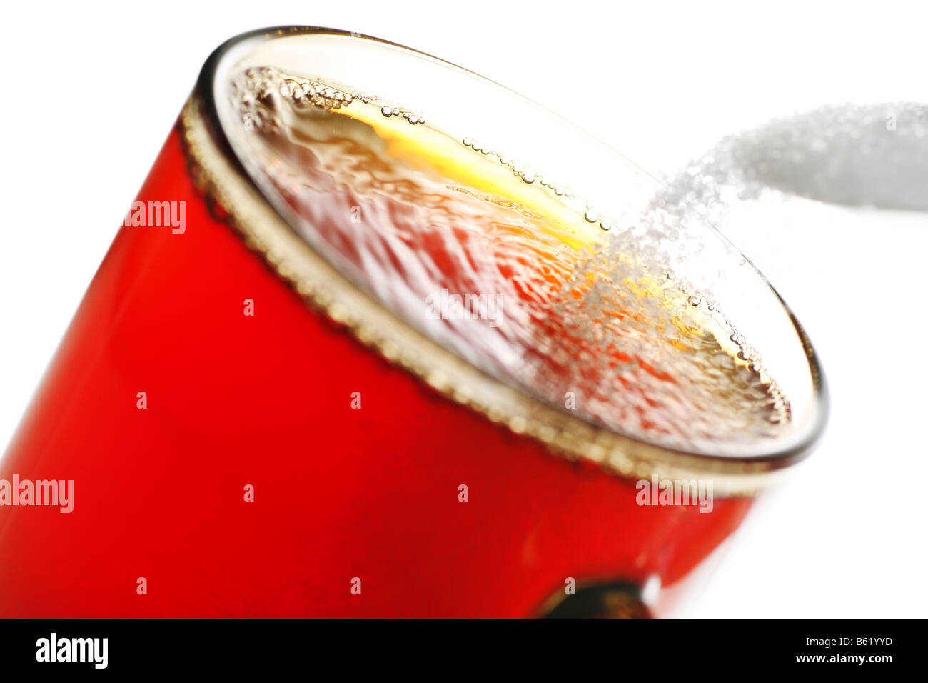 freshly brewed cup of tea with falling sugar granules Stock Photo