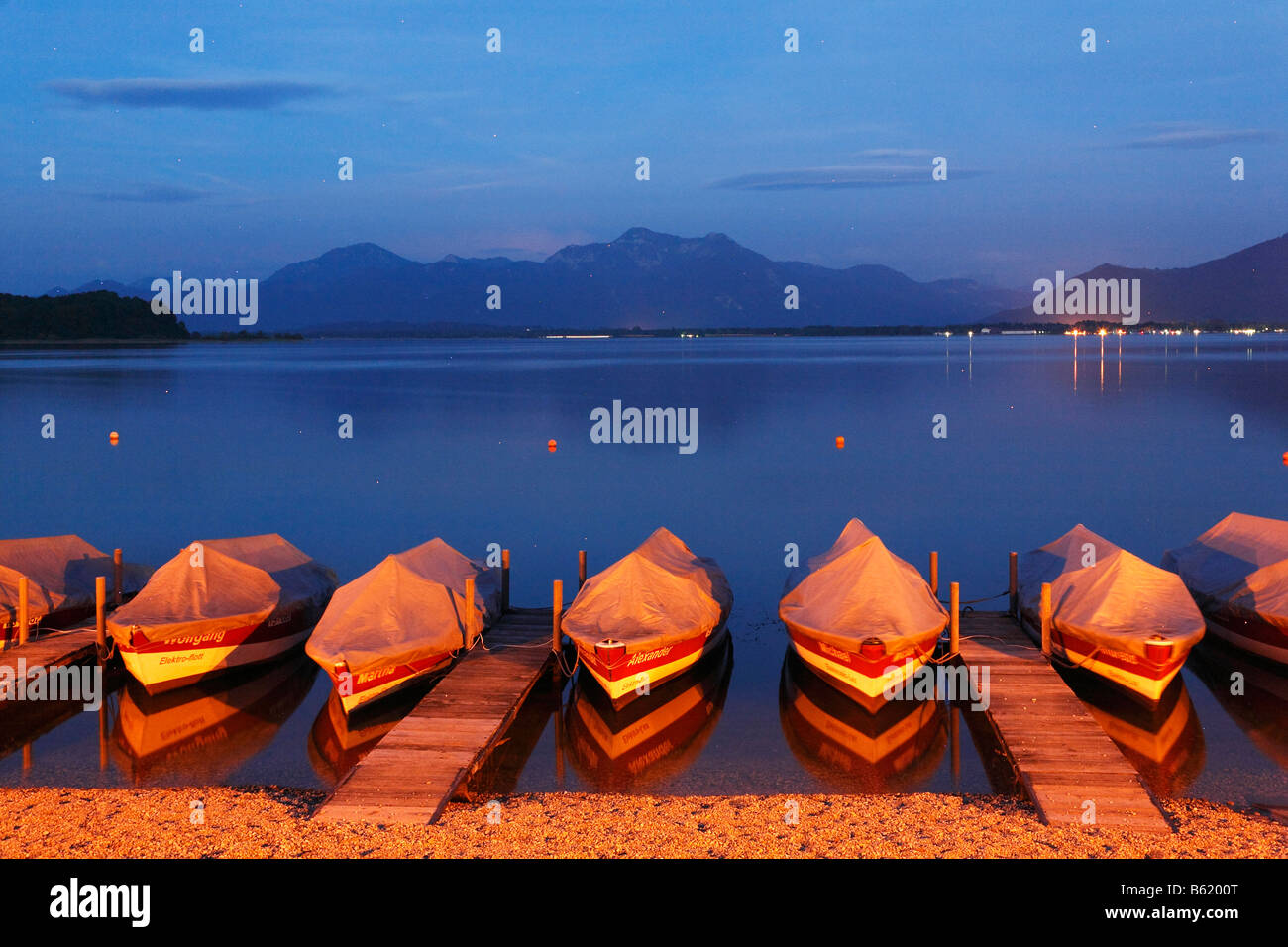 Night-time illuminated boats in Prien, Lake Chiemsee, Chiemgau, Upper Bavaria, Germany, Europe Stock Photo