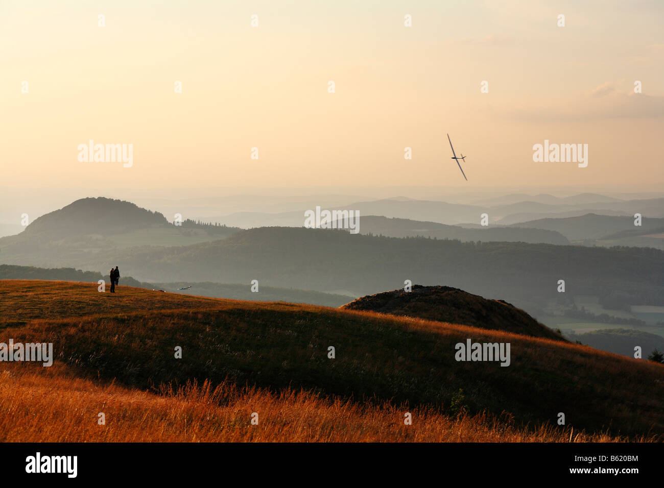 Radion controlled model plane flying over the Abtsrodaer Kuppe or Hill, Wasserkuppe, Rhoen, Hesse, Germany, Europe Stock Photo