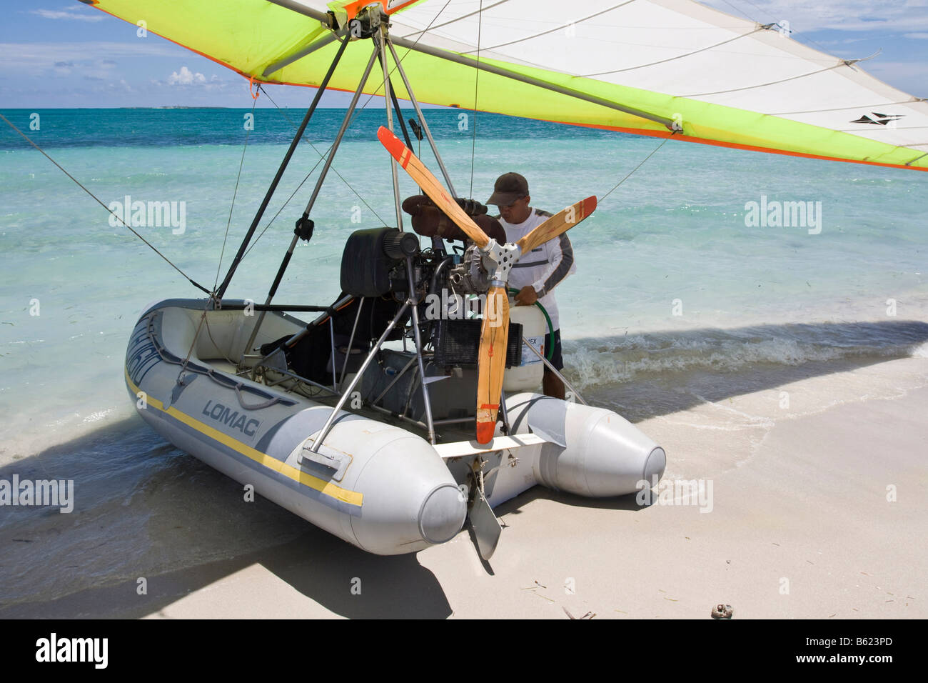 Motorised hang glider being refueled, UL-Trike, Ultra Light airplane with a life boat, Varadero, Cuba, Caribbean, Central Ameri Stock Photo