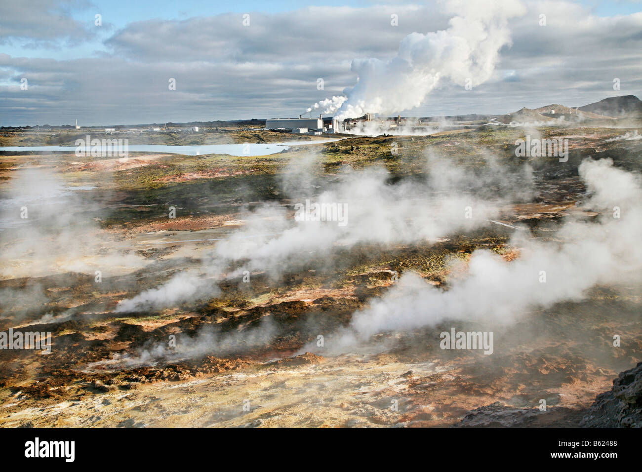 Steam from the countless holes and fractures in the earth's crust, the Solfatarten, behind it a geothermal power station and a  Stock Photo