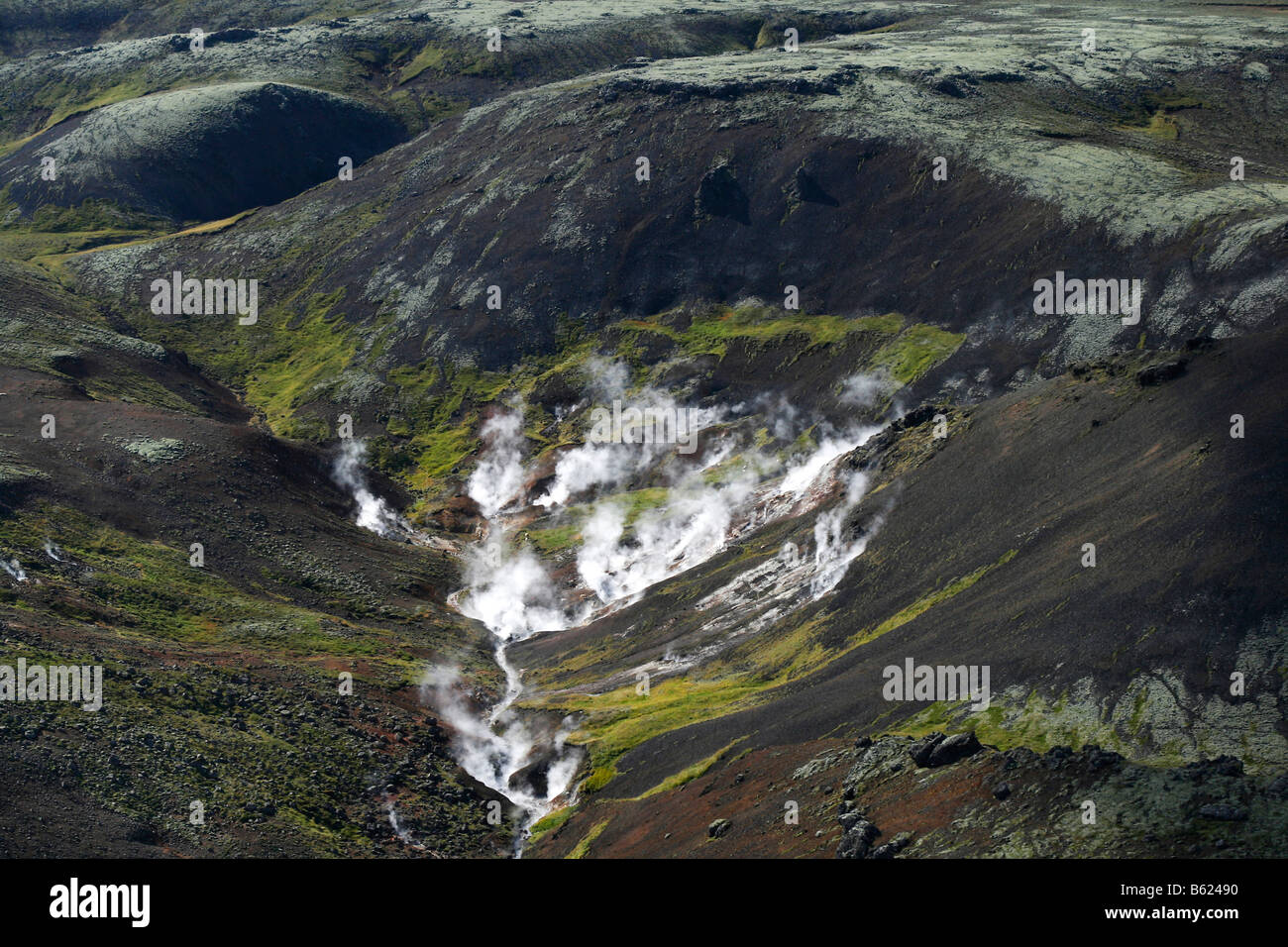 Hot springs steam in the geothermal area on Hengill Volcano near the Nesjavellir geothermal power station in southern Iceland,  Stock Photo