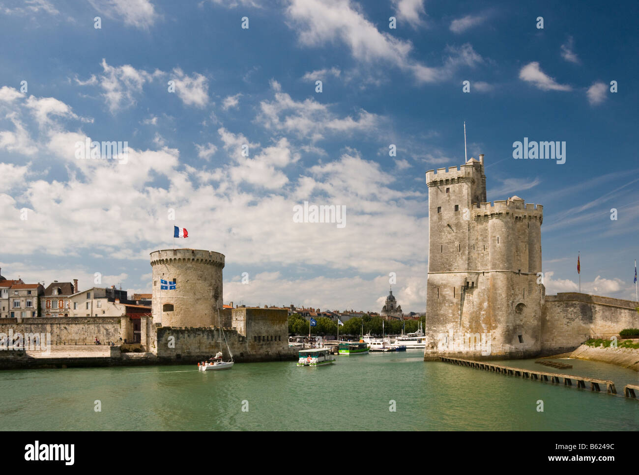 The towers of La Chaine and St Nicholas at the entrance to the ancient port of La Rochelle Charente Maritime France Stock Photo