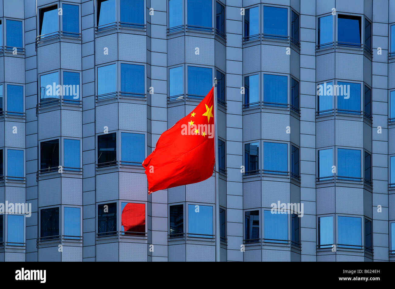National flag blowing in the wind in front of the facade of the Chinese embassy, Berlin, Germany, Europe Stock Photo