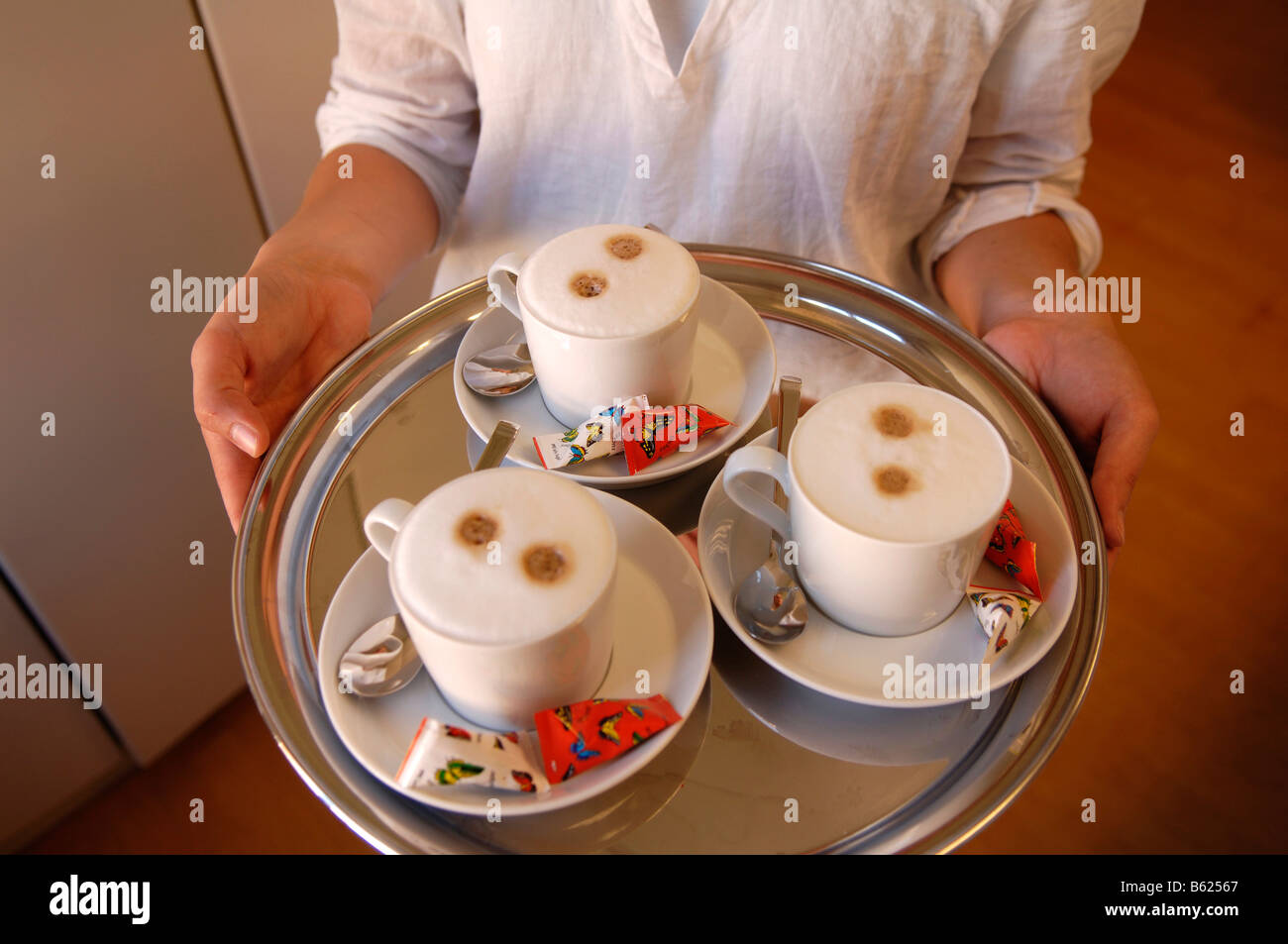 Three cappuccino served on a silver tray, Nuremberg, Middle Franconia, Bavaria, Germany, Europe Stock Photo