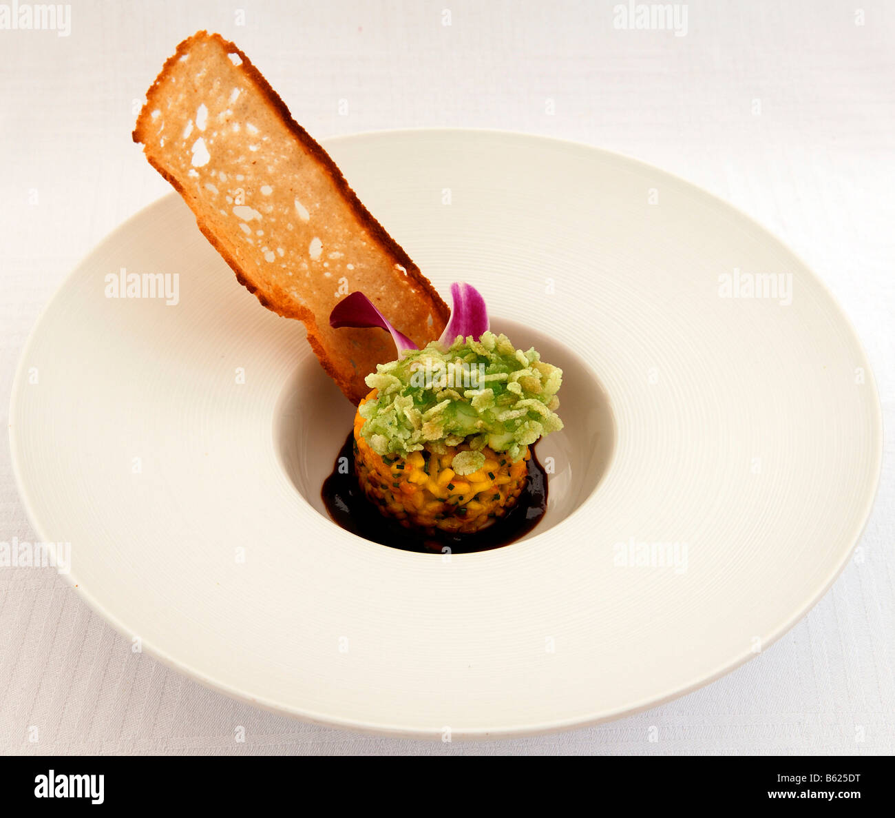 Seadevil in green rice on safran risotto, food, haute cuisine Stock