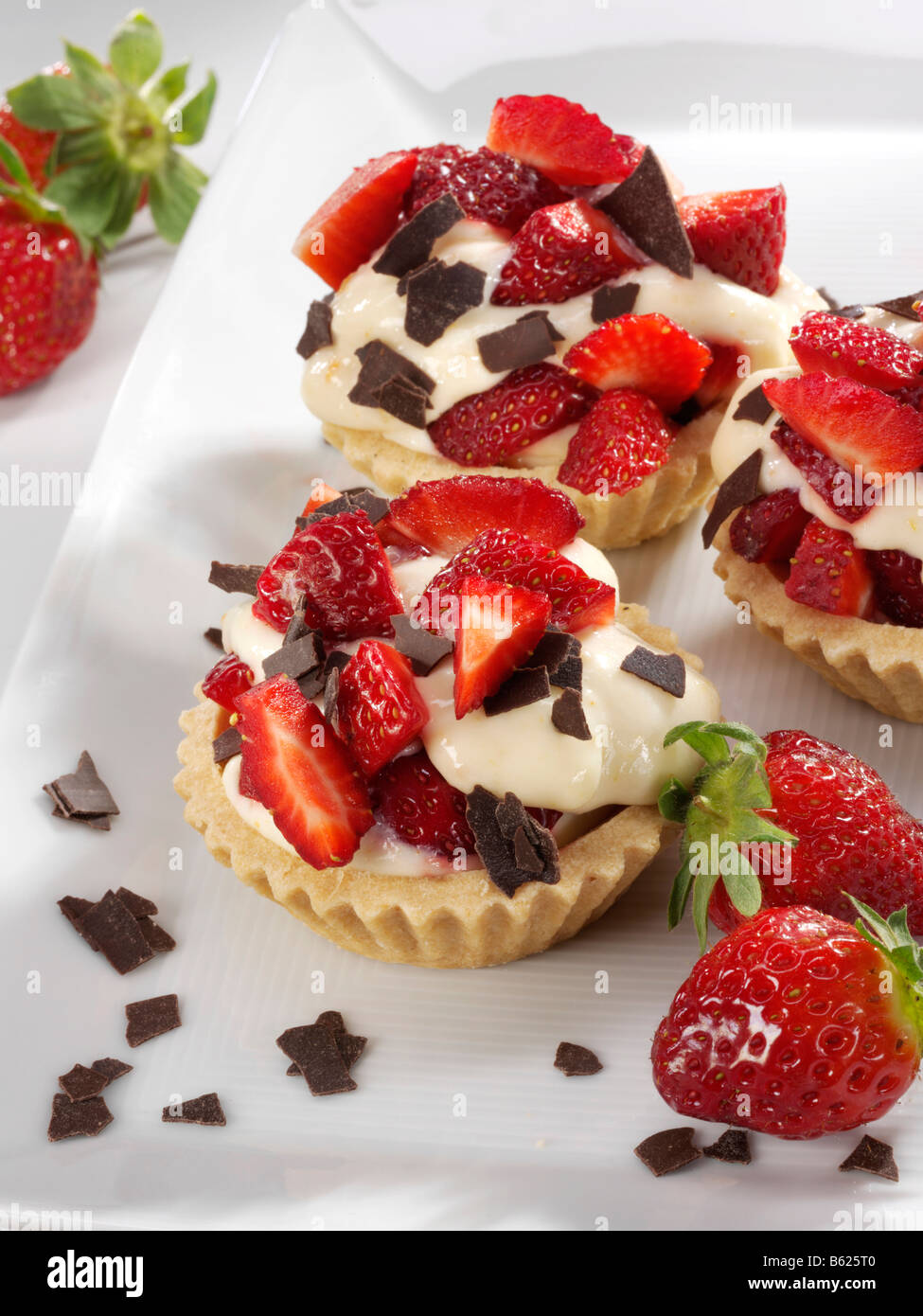 Strawberry tarts with fresh strawberries and chocolate crumbles Stock Photo