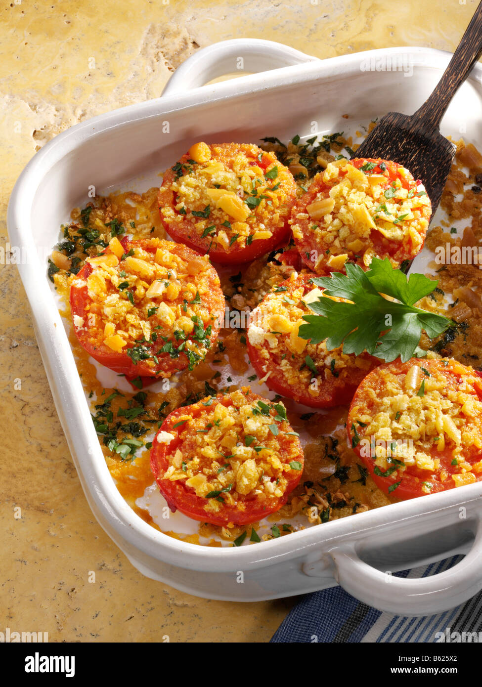 Oven-cooked tomatoes in a casserole dish Stock Photo