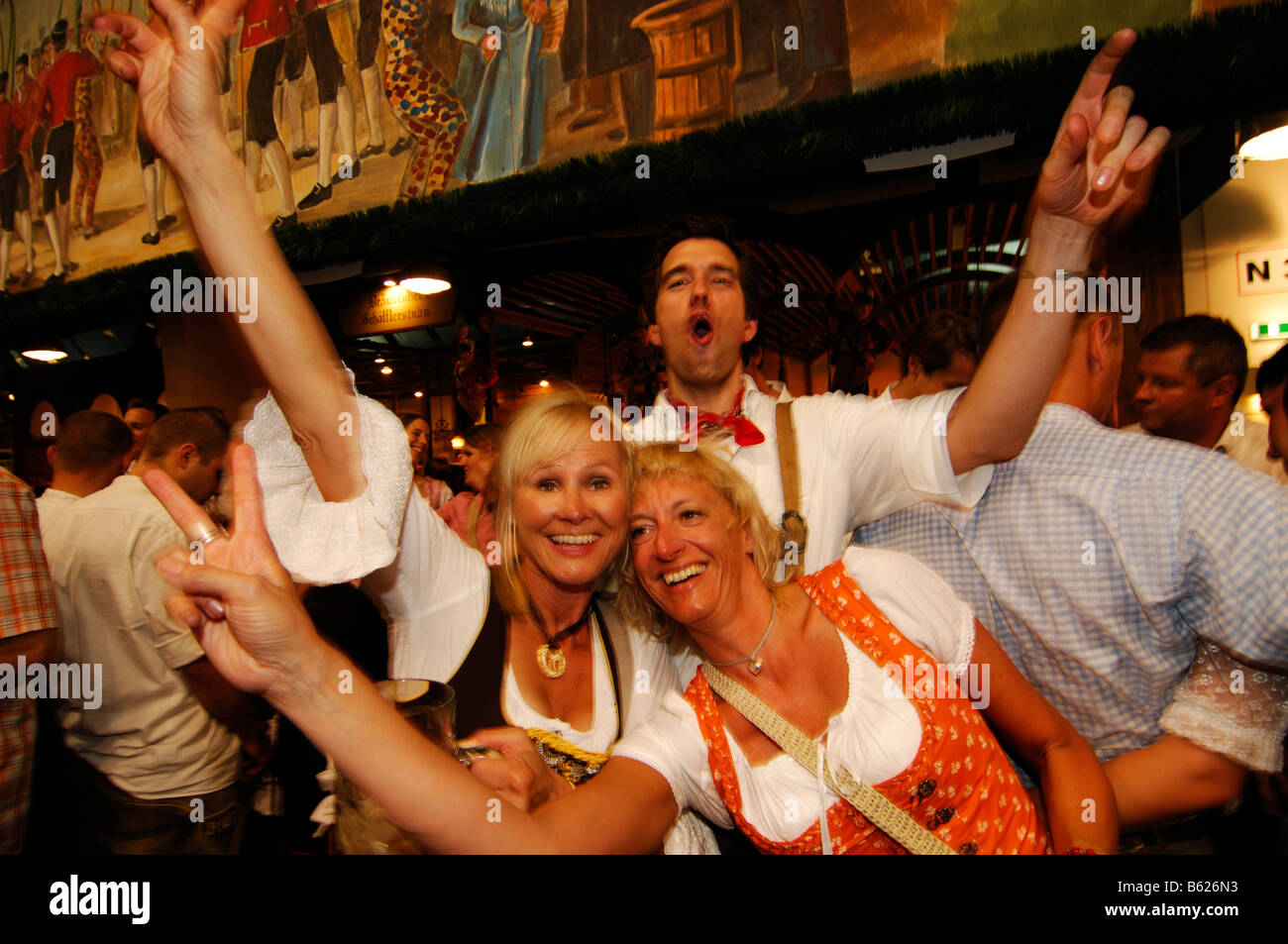 Women wearing traditional dress, called a Dirndl, dancing in the Beer Tent at the Oktoberfest Beer Festival or Wies'n in Munich Stock Photo - Alamy Women wearing traditional dress, called a Dirndl, dancing in the Beer Tent at the Oktoberfest Beer Festival or Wies'n in Munich Stock Photo - Alamy
