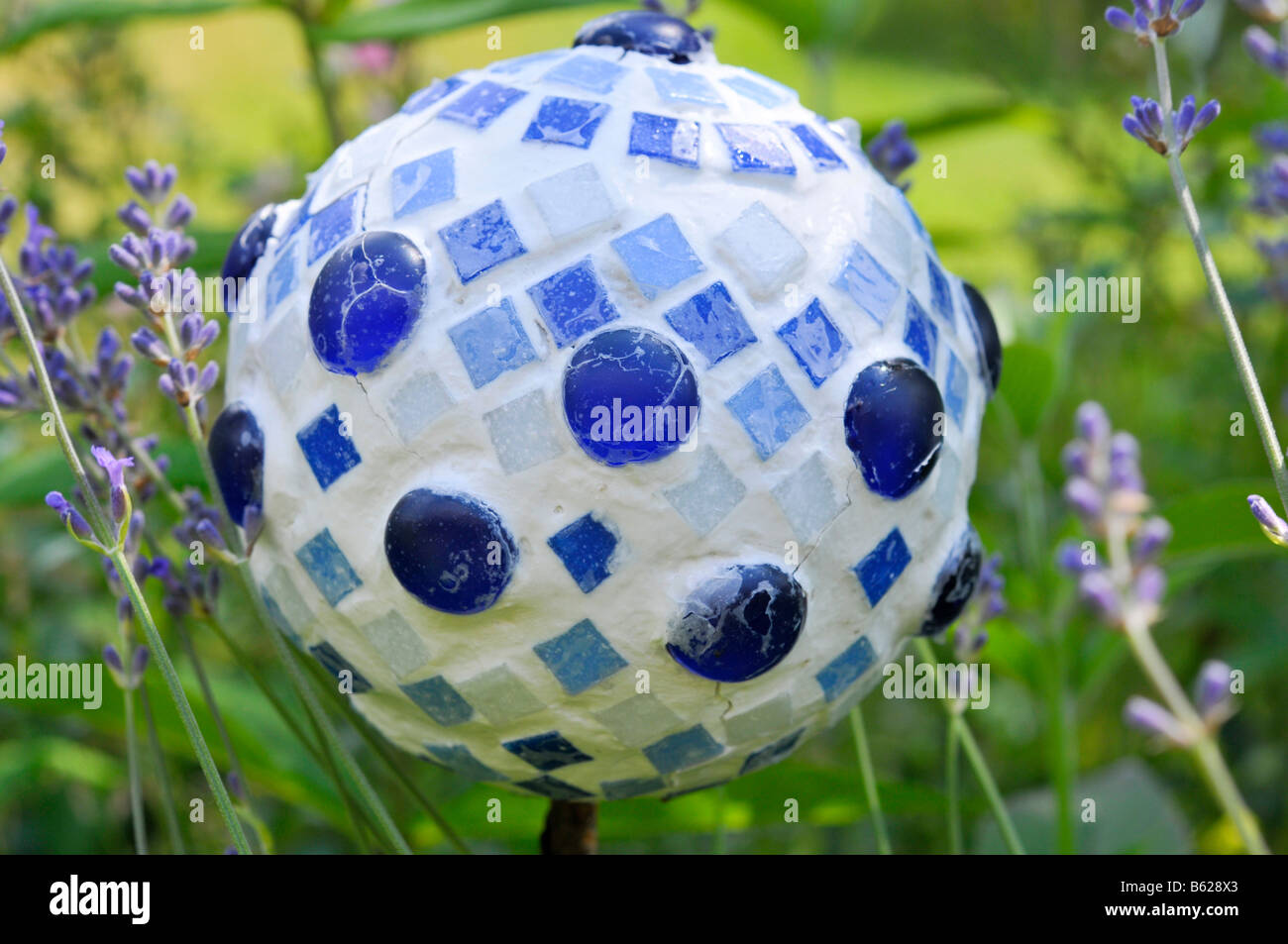 Blue and white decorative ball in the garden Stock Photo Alamy
