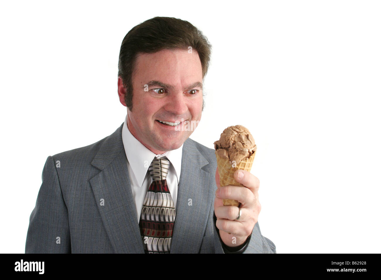 A businessman looking at an ice cream cone with a crazed look Stock Photo