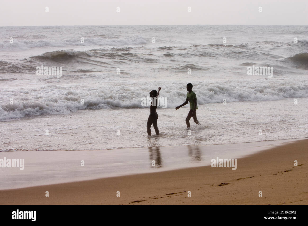 Two boys playing in the sea. Marina Beach, Chennai, Tamil Nadu, India. Stock Photo