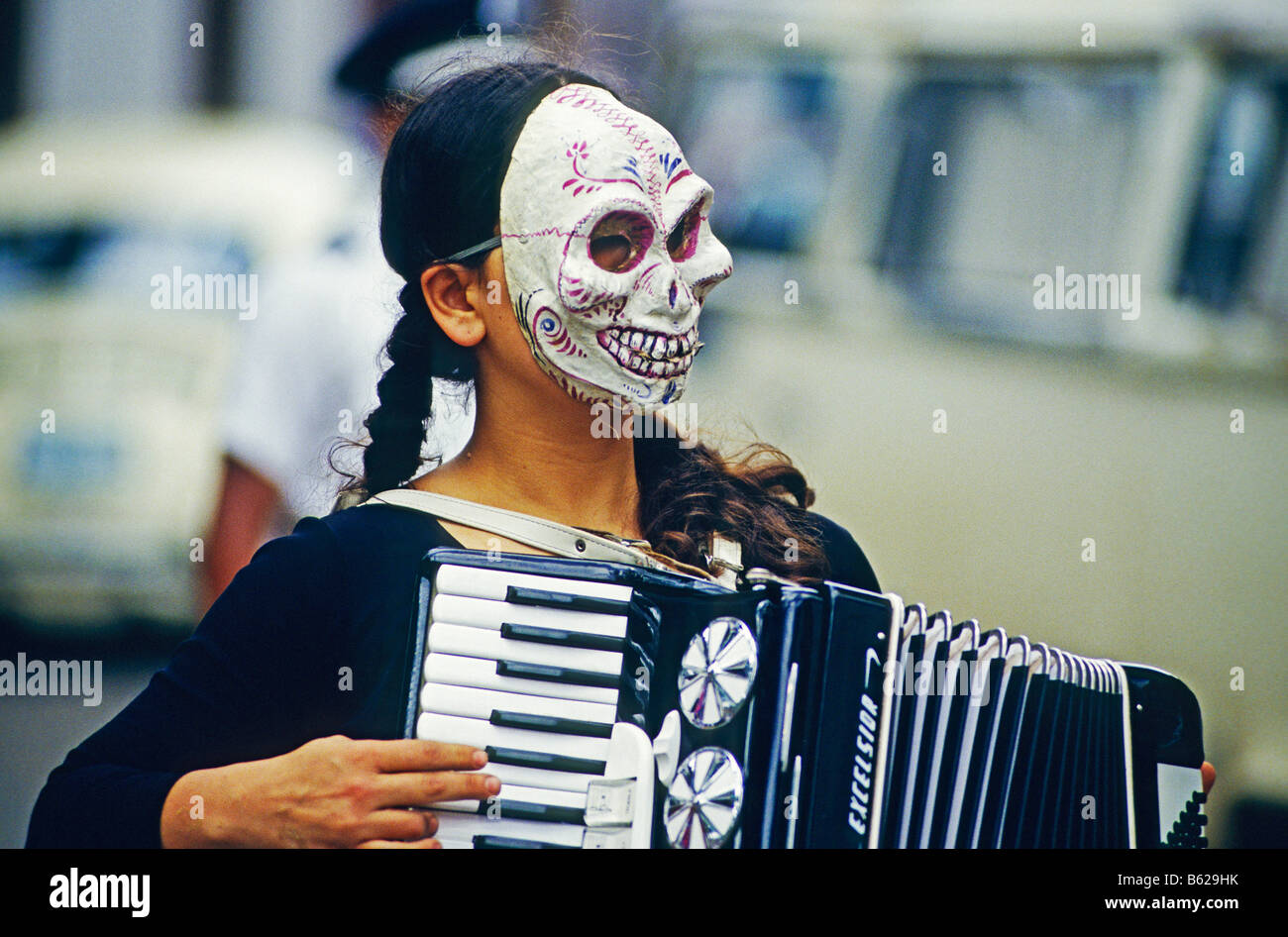 Accordion player wearing a skull or death mask during the Day of the Dead Festival, held on All Saints' Day or All Hallows in P Stock Photo