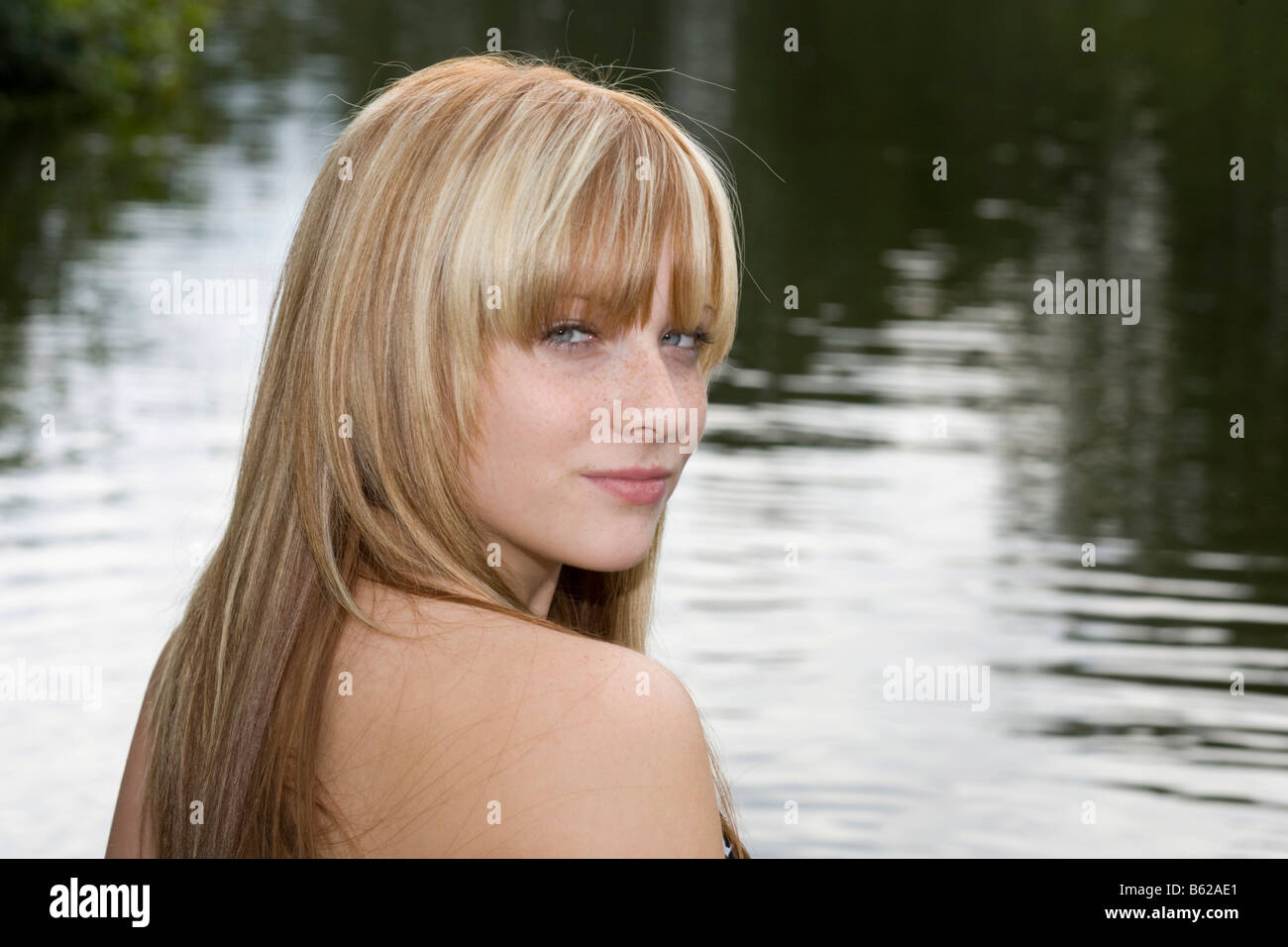 Portrait of a young, blonde woman by the water Stock Photo