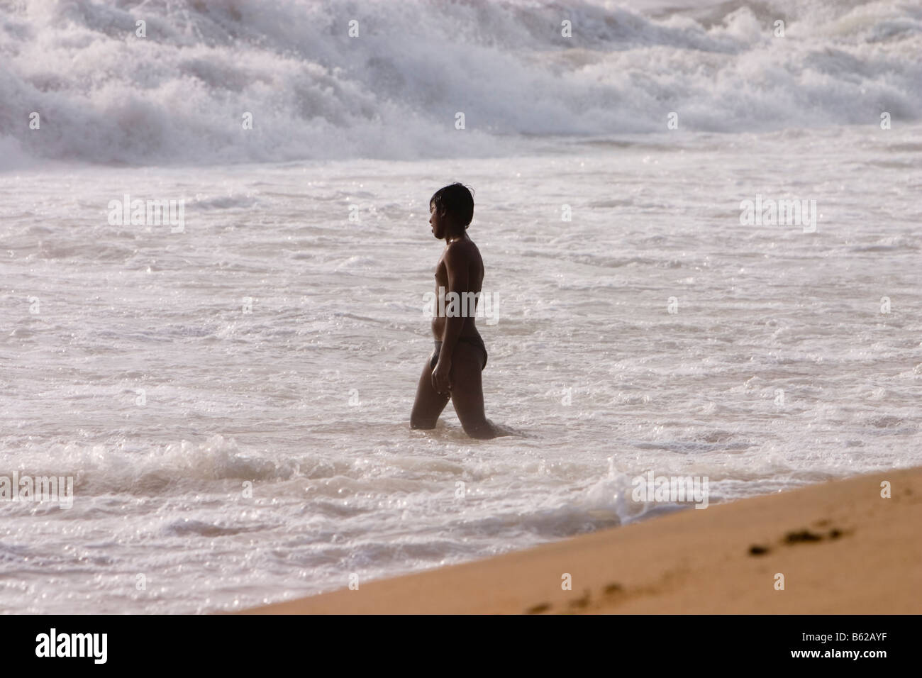 A boy playing in the sea. Marina Beach, Chennai, Tamil Nadu, India. Stock Photo