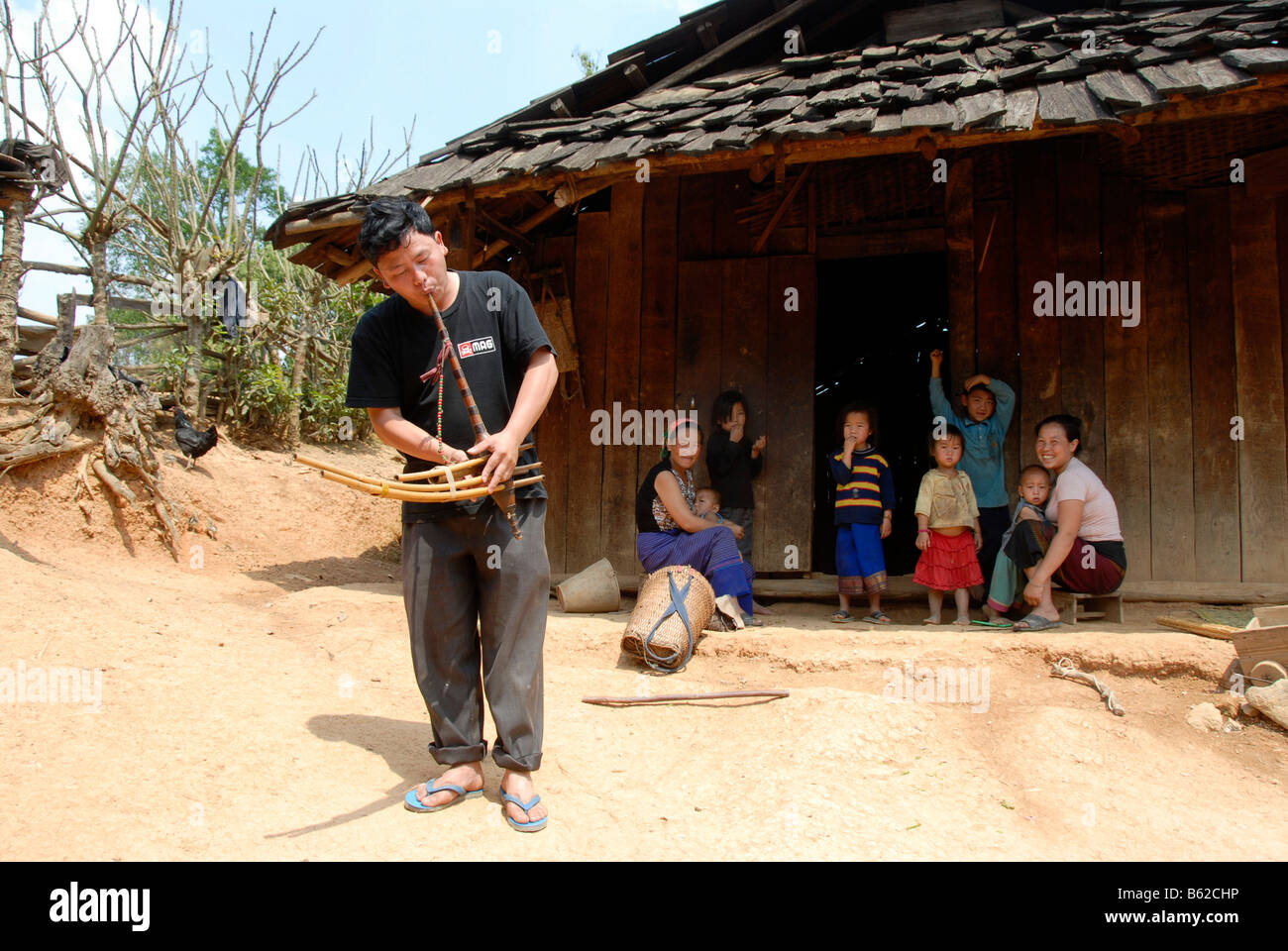 Hmong musician playing the flut in the village, a traditional instrument, Phakeo, Xieng Khuang Province, Laos, Southeast Asia Stock Photo