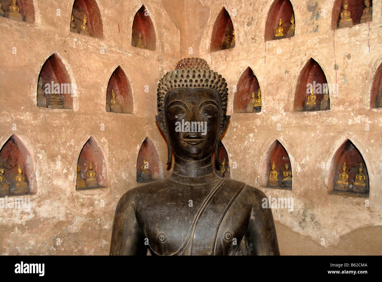 Bronze Buddha statue in a corner, Wat Sisaket, Vientiane, Laos, South East Asia Stock Photo