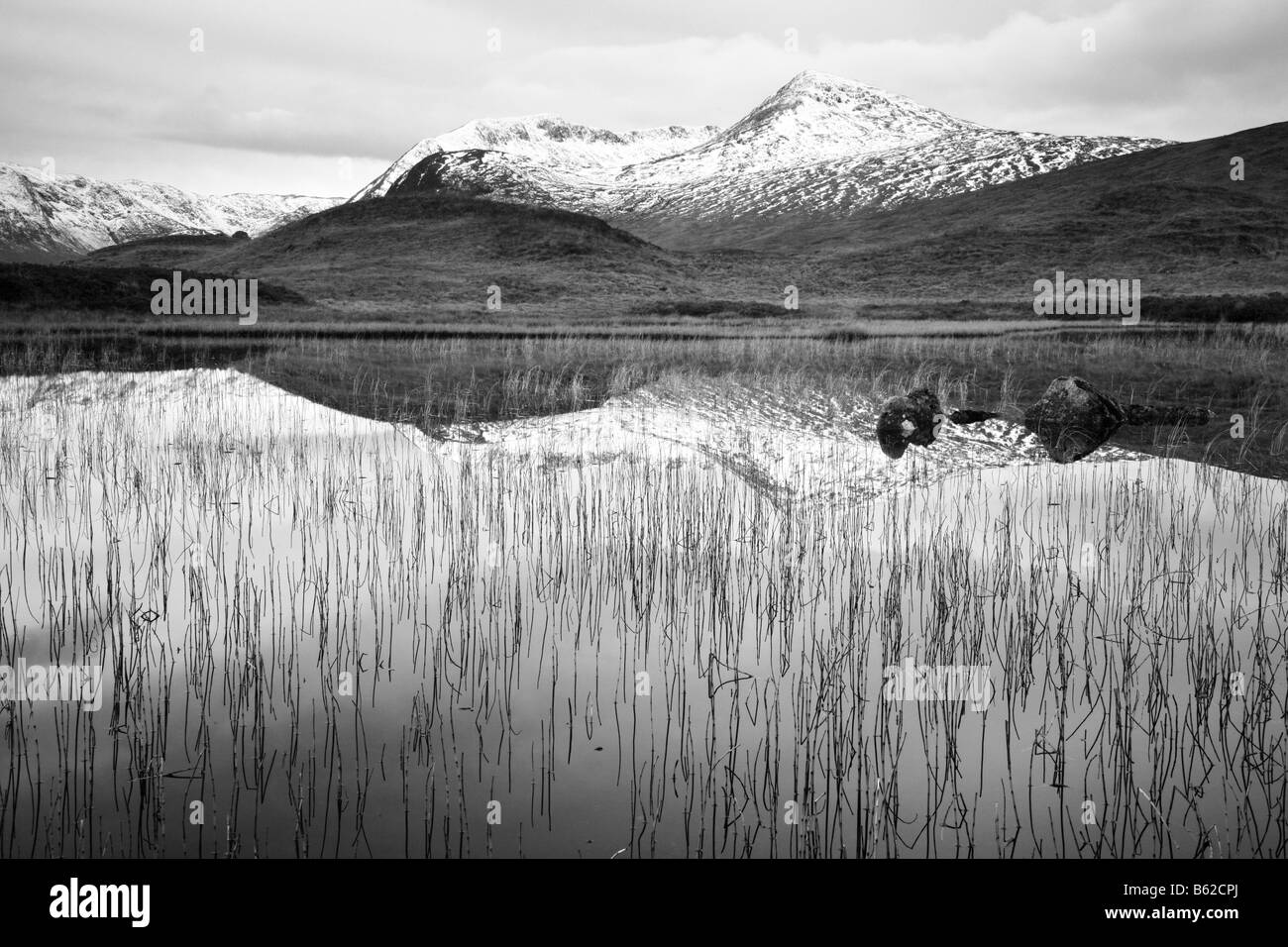 Reflective late autumn view of the Blackmount Estate Peaks at Rannoch Moor as seen in Lochan Nah Achlaise Stock Photo