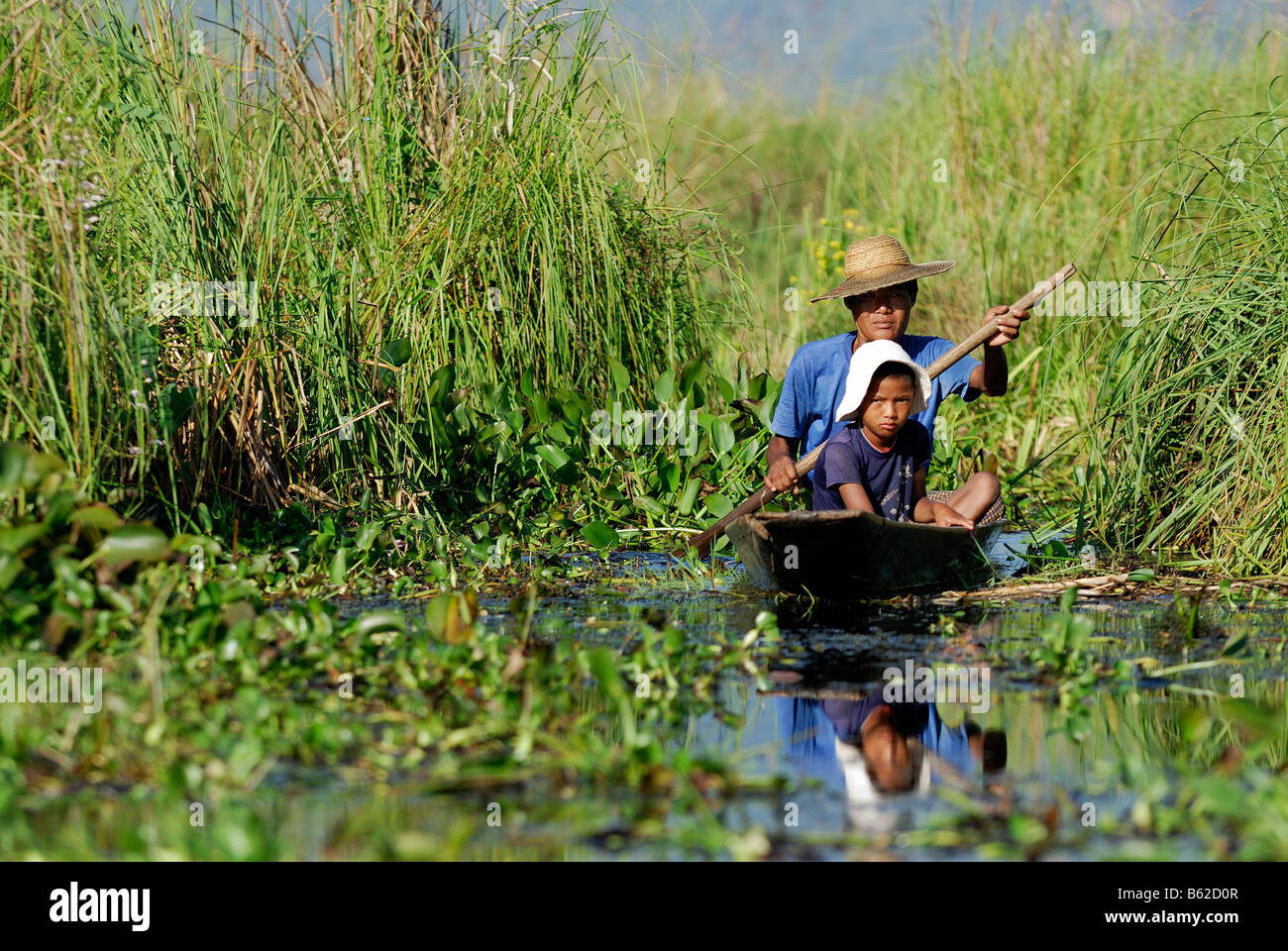 Burmese with child and boat, Inle Lake, Myanmar, Burma, South East Asia Stock Photo