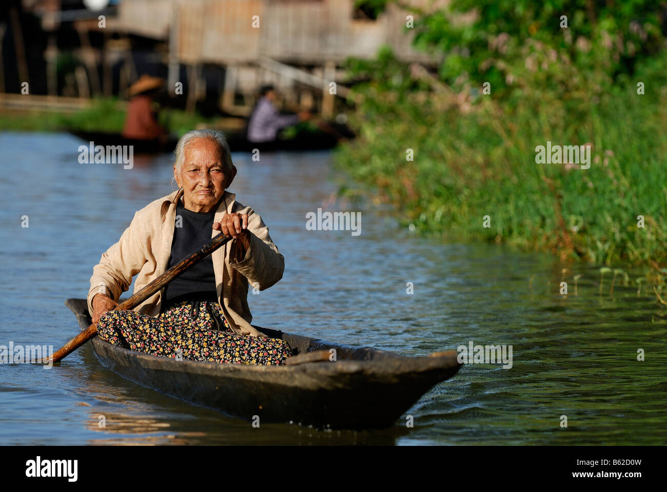Old Burmesee woman in a boat, Inle Lake, Myanmar, Burma, South East Asia Stock Photo