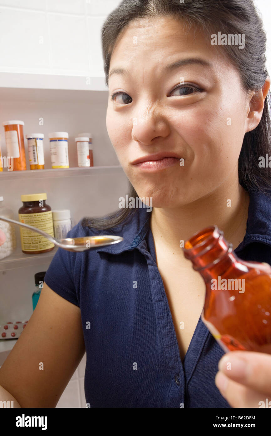 Woman at home does not like taking cough syrup Stock Photo Alamy