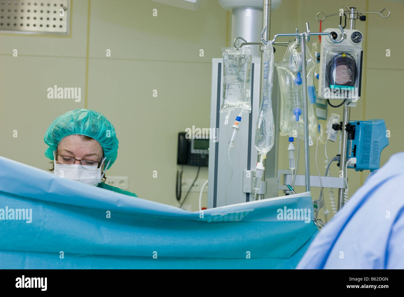 Surgial nurse monitoring patient during neurosurgery to remove a benign brain tumor, Reykjavik Iceand Stock Photo