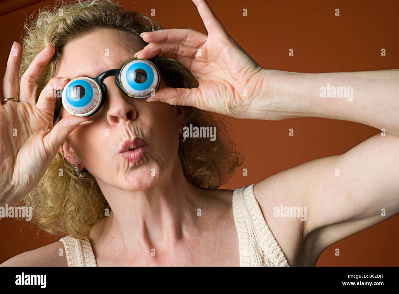 portrait of a woman clowning and wearing novelty eyeglasses Stock Photo