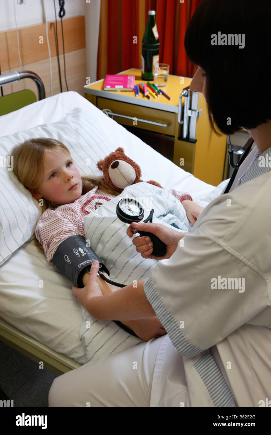 Nurse is checking the blood pressure of a child patient in a hospital ...
