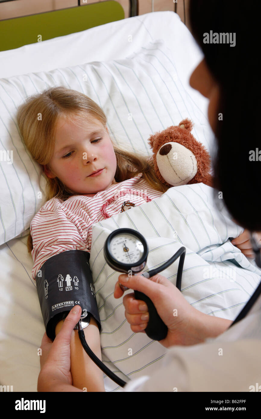 Nurse is checking the blood pressure of a child patient in a hospital ...