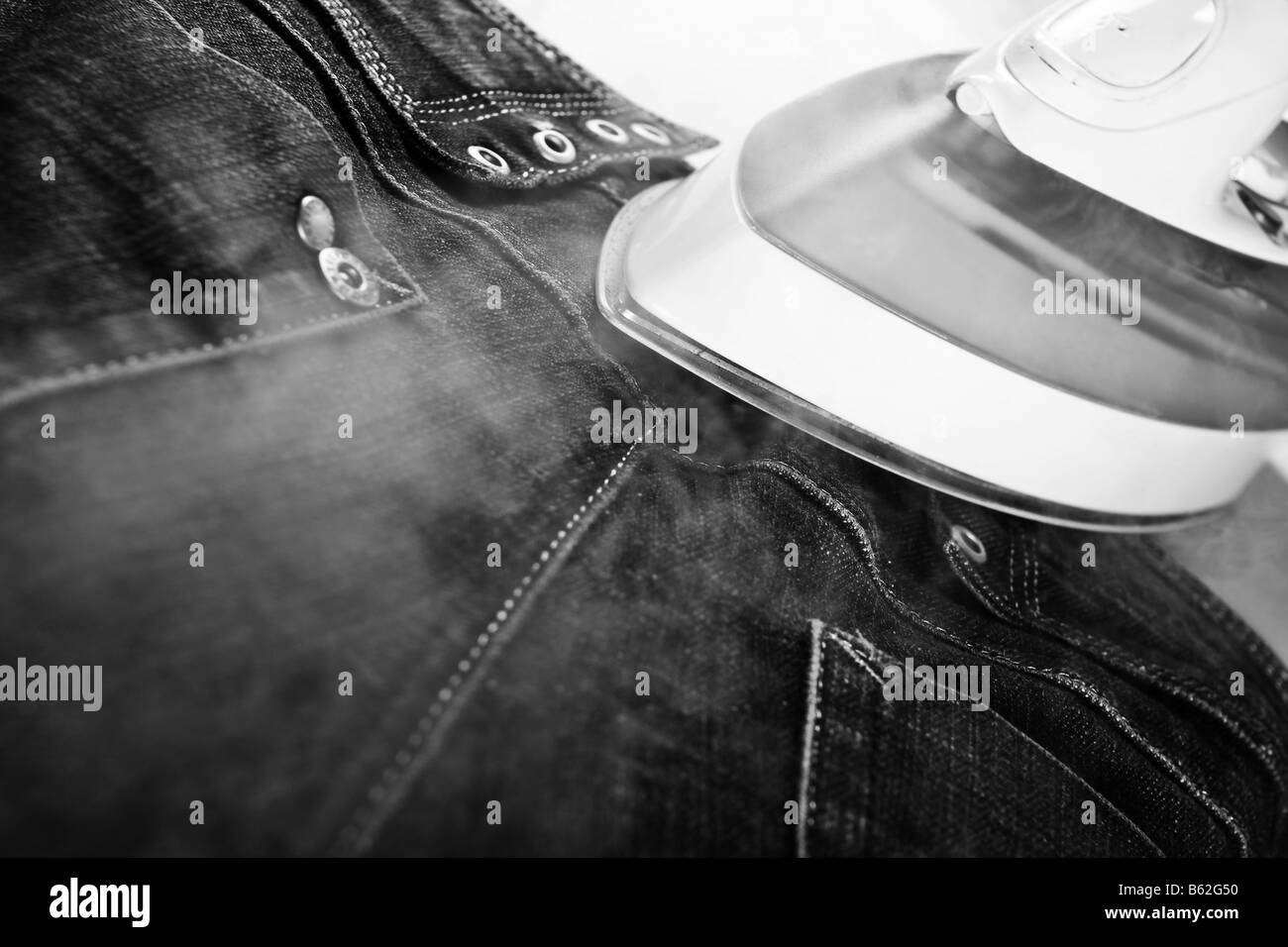 steam iron and jeans Stock Photo Alamy