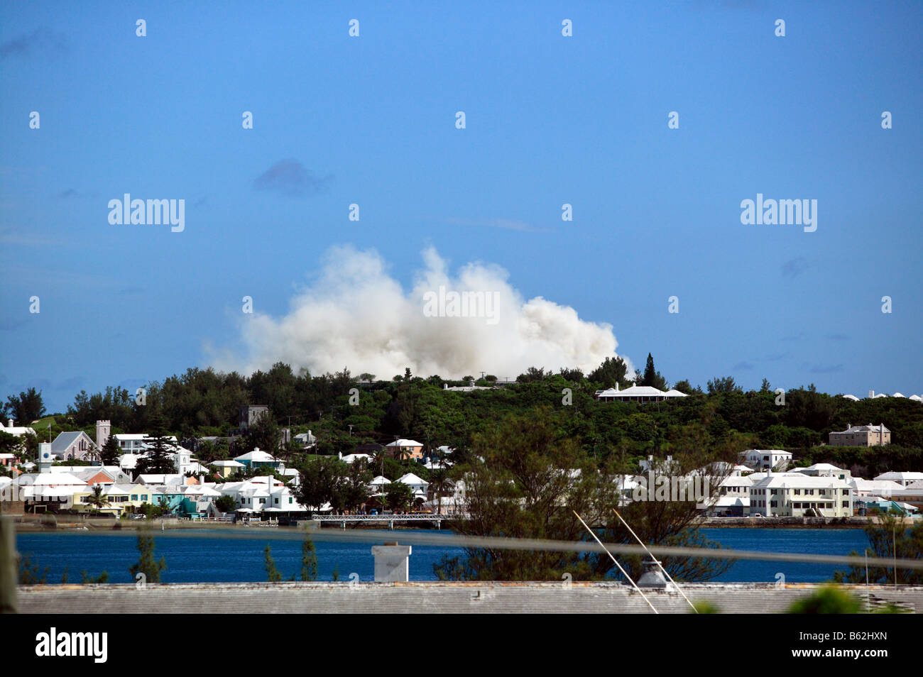 A huge dust cloud rises over the former Club Med Hotel as thousands of tons of concrete collapse after the implosion Stock Photo