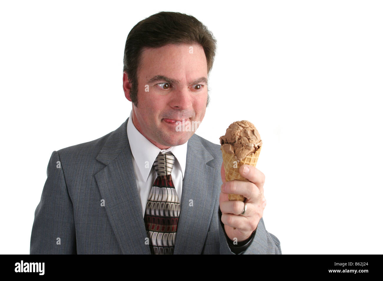 A businessman drooling and looking at a chocolate ice cream cone Stock Photo