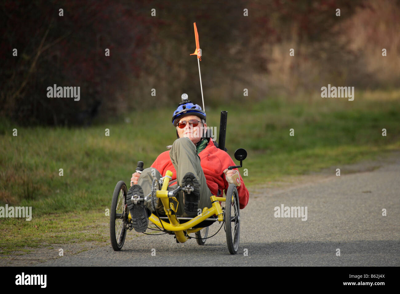 Senior gentleman tricycling on sunny autumn day Victoria British Columbia Canada Stock Photo