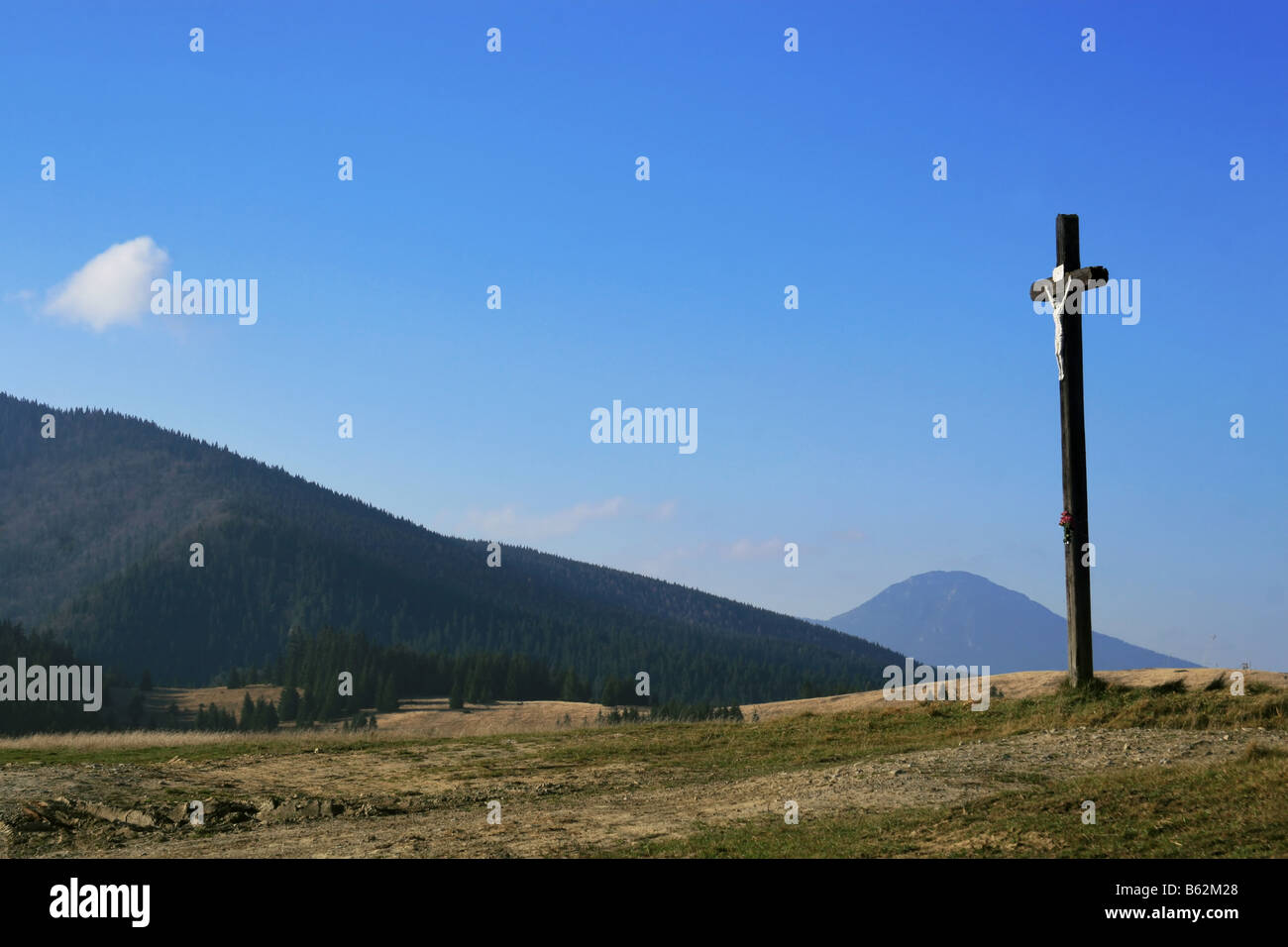 Lonely cross in the mountains. Stock Photo