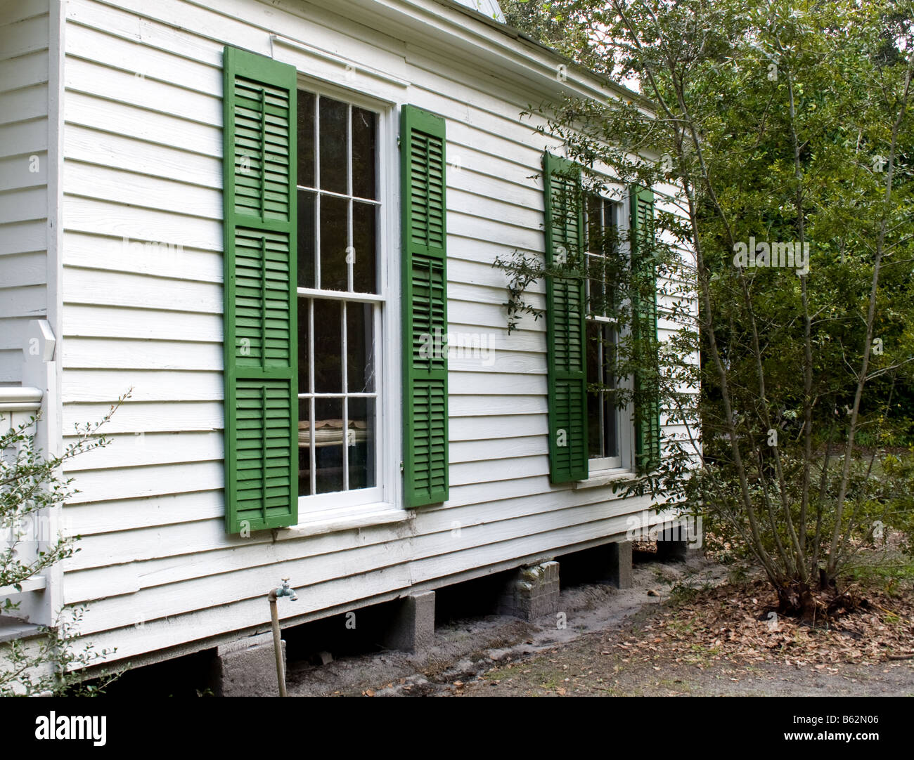 Side of a white house with green shutters on the windows in Mandarin, Jacksonville, Florida Stock Photo