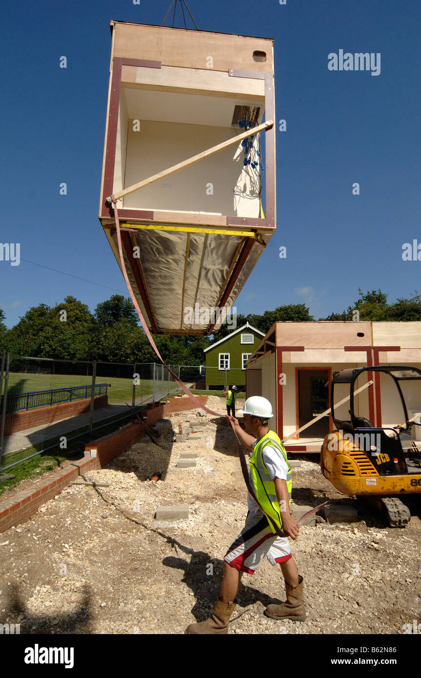 lowering in modular building section in to place by crane Stock Photo ...