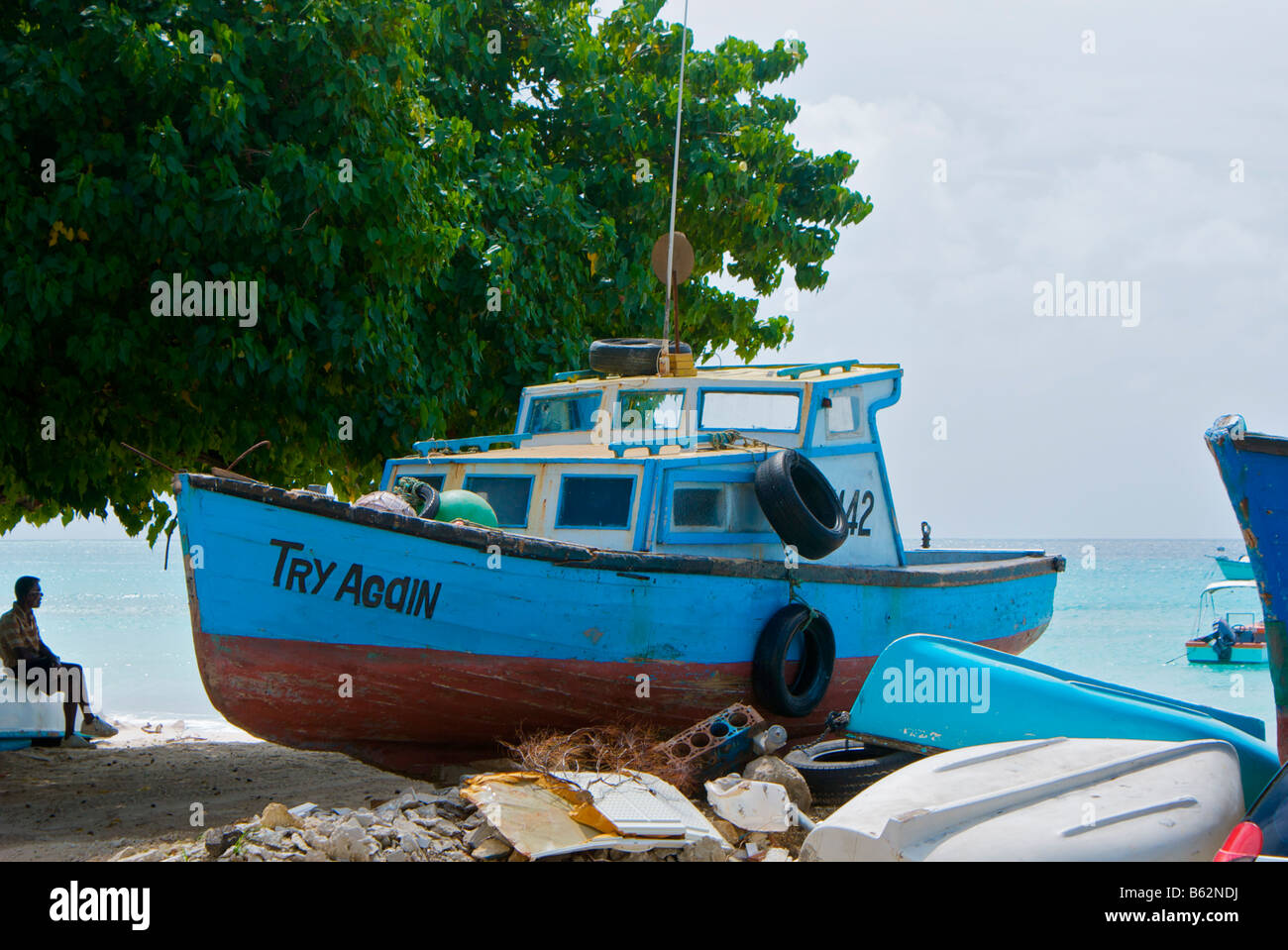 Fishing boat beached on the shore at Oistins, Barbados Stock Photo