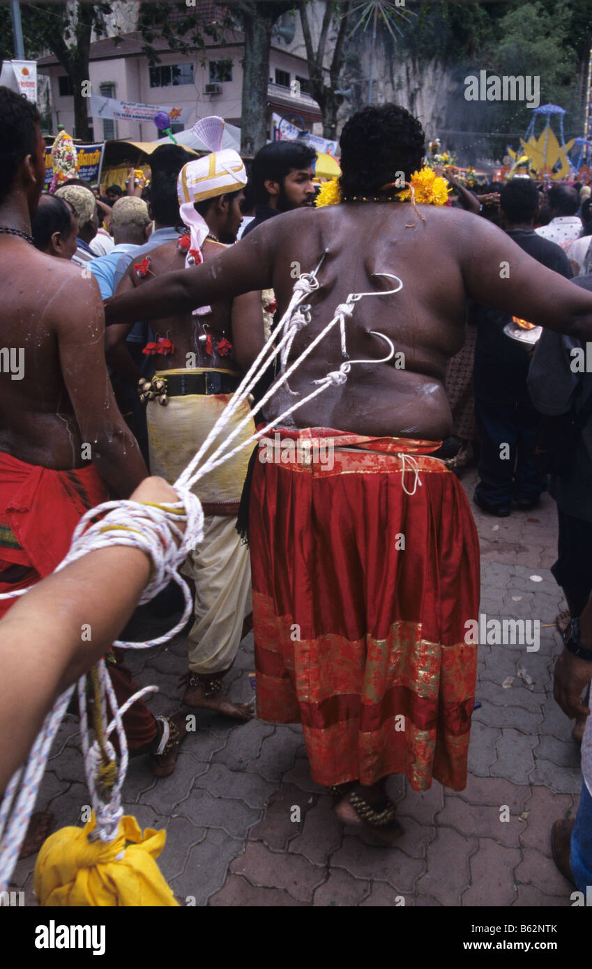 A fat Hindu penitent with pierced back during the annual Thaipusam Festival at Batu Caves, Kuala Lumpur, Malaysia Stock Photo