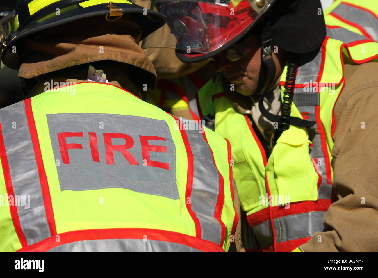 Firefighters working on extricating victims from a car rollover accident Stock Photo