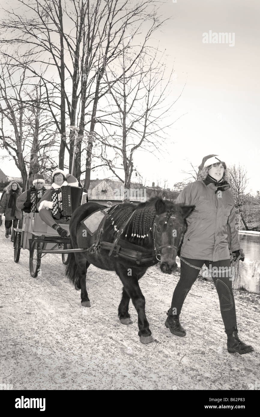 Santa claus parade with horse wagon at swedish traditional Christmas celebration svensk tomteparad med häst och vagn s/v b/w Stock Photo