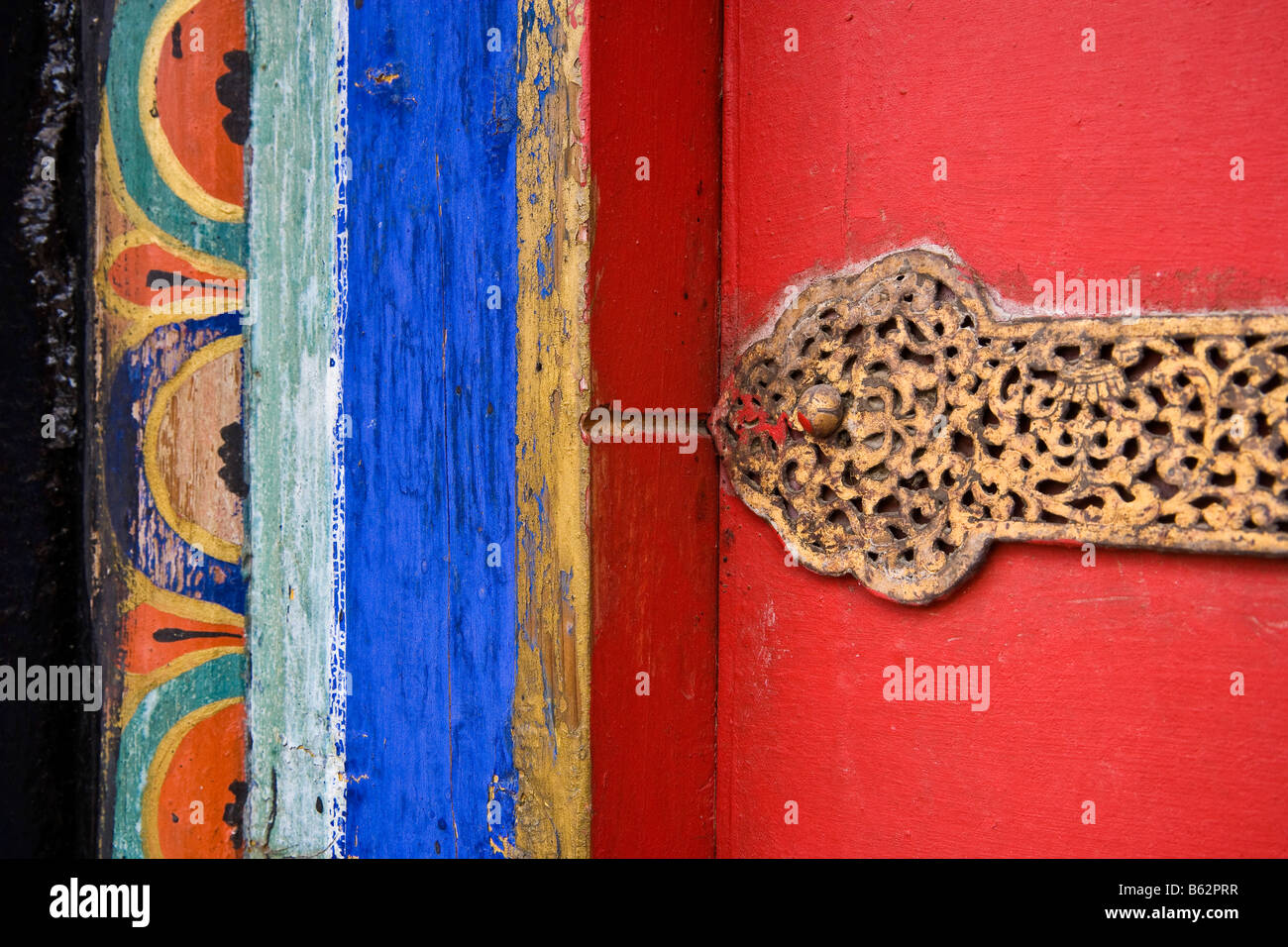 Brass Filigree Door Hinge And Painted Door Jamb Detail At The