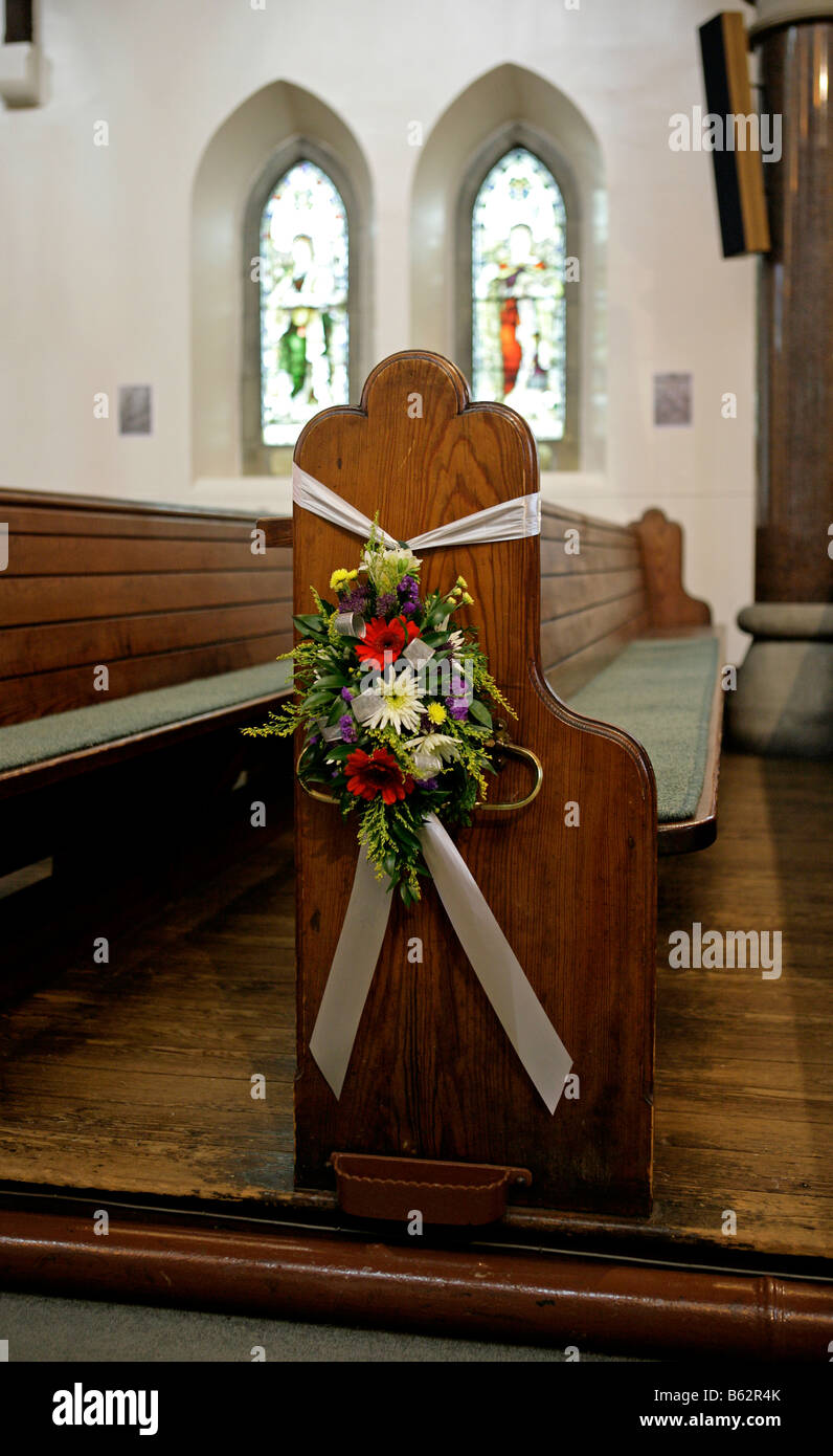 flower on the end of a pew in a church wedding day celebration flower
