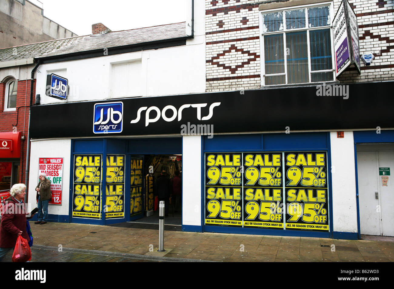 Famous UK high street retail sports shop displays 95 percent sale signs in window during global economic recession downturn Stock Photo