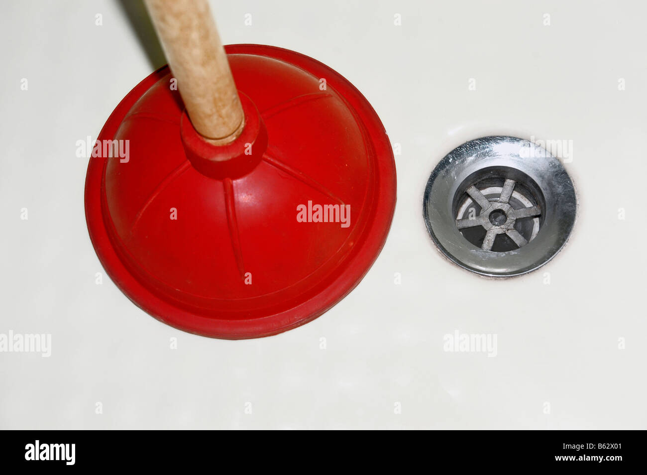 A plunger and  drain. Stock Photo