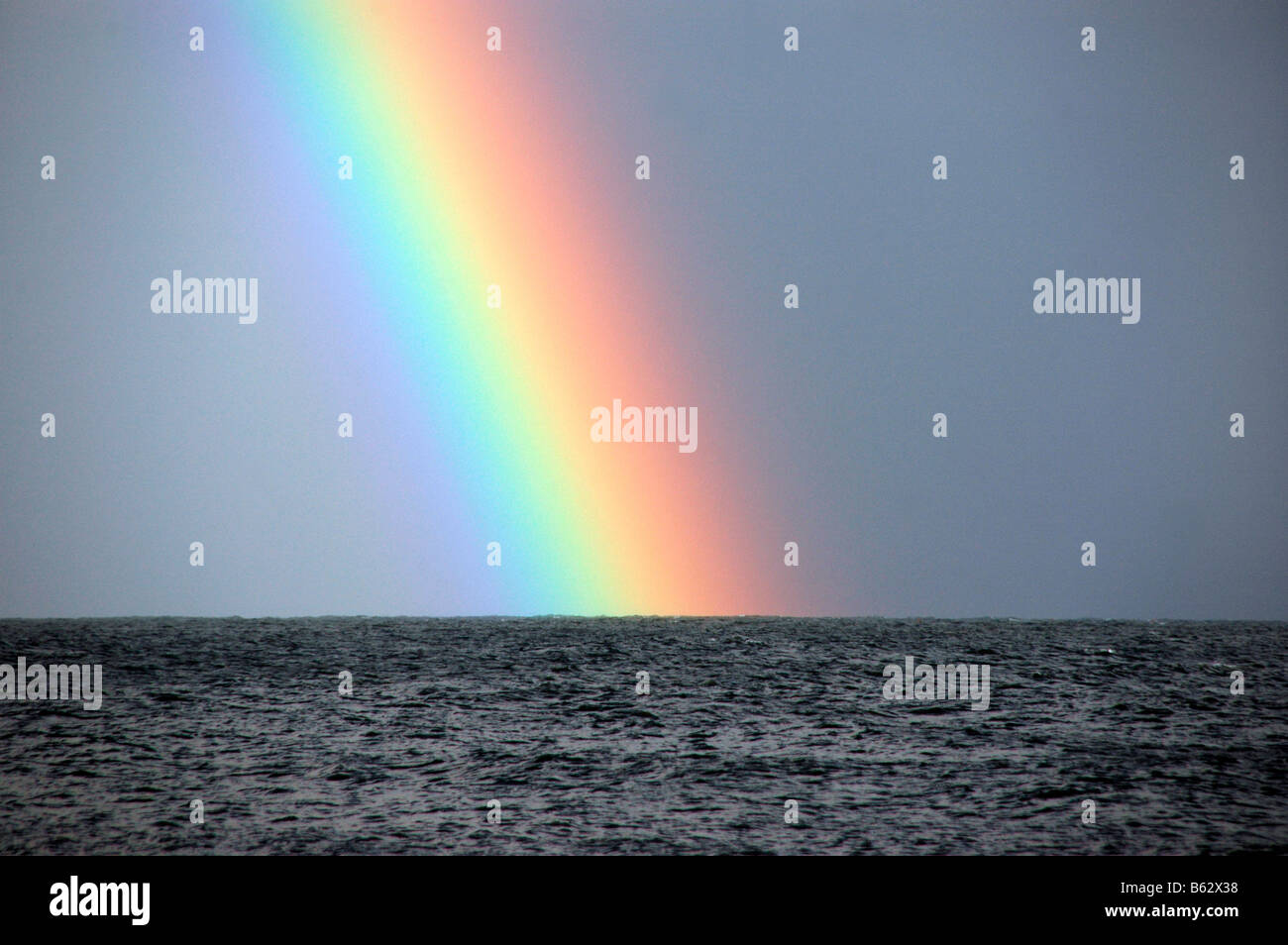 A zoomed view of a rainbow at sea. Stock Photo