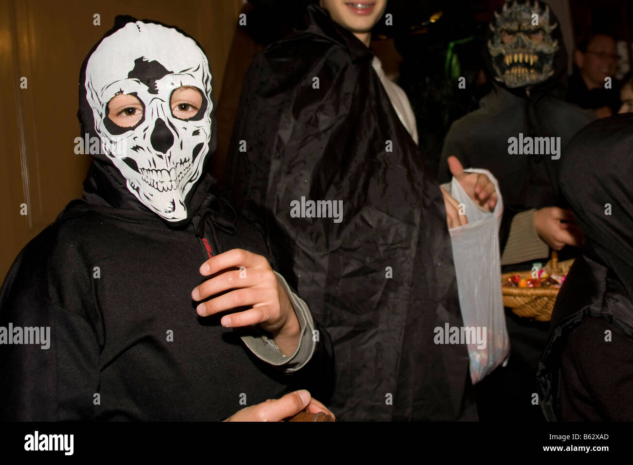 Young people trick and treat halloween party wearing masks black shirts