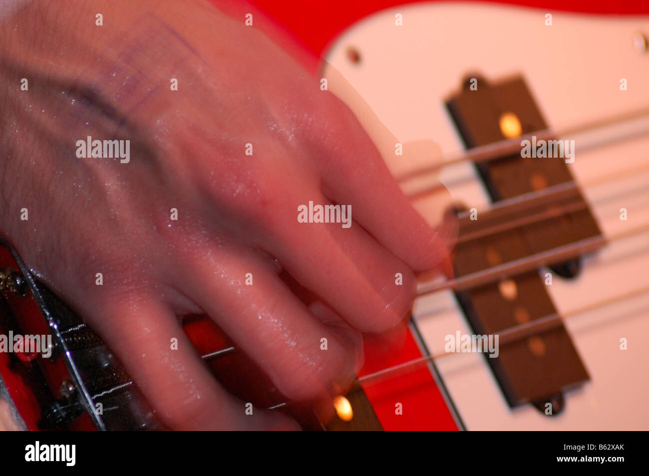Close up of guitarist's hand strumming an electric guitar Stock Photo