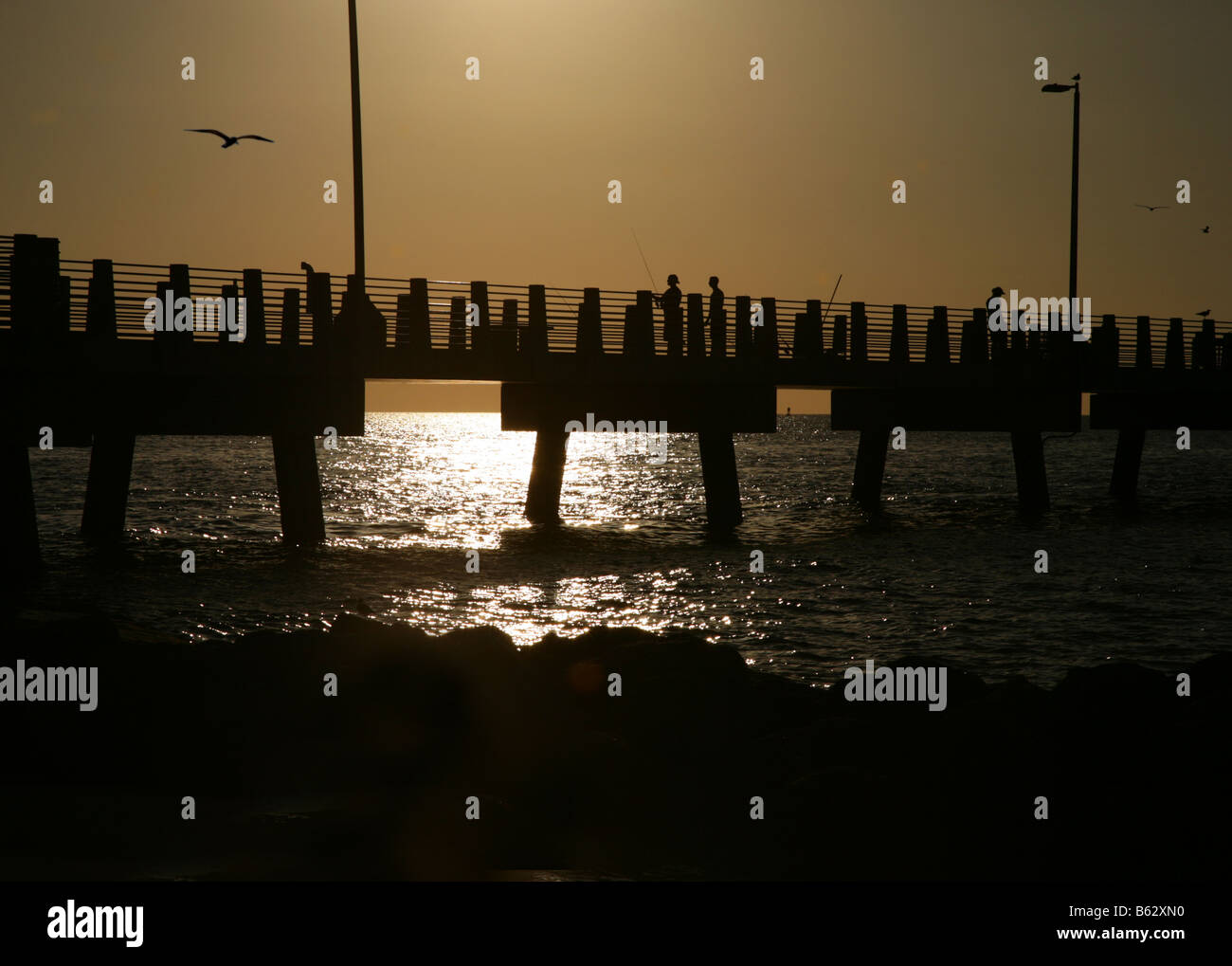 The fishing pier at Fort De Soto Pinellas Couty Florida at night as the sun sets Stock Photo